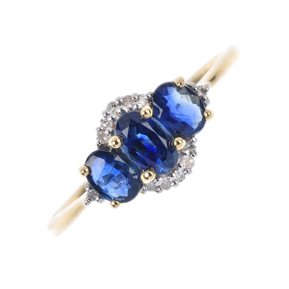 An 18ct gold sapphire and diamond three-stone ring. (1 of 4)