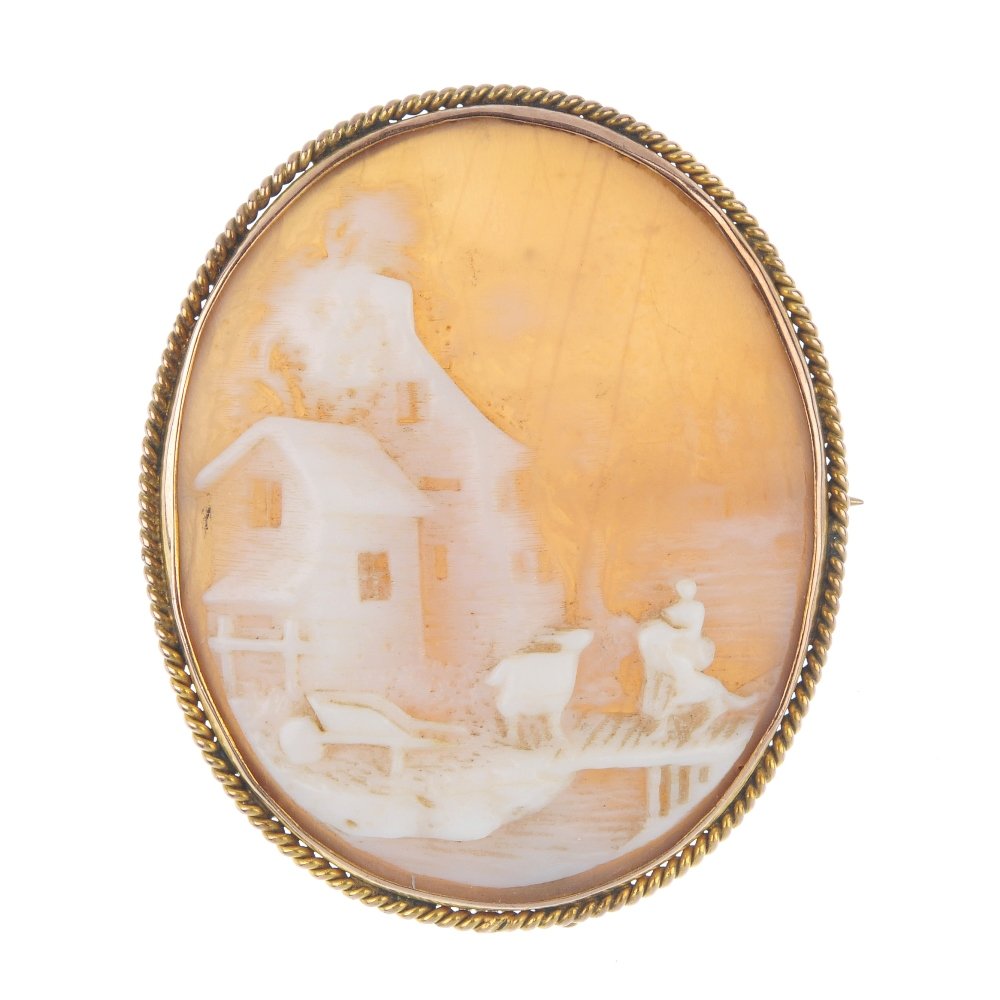 A cameo brooch.: A cameo brooch. The shell depicting a mill and pastoral scene, to the rope-twist surround. Length 4cms. Weight 7gms.