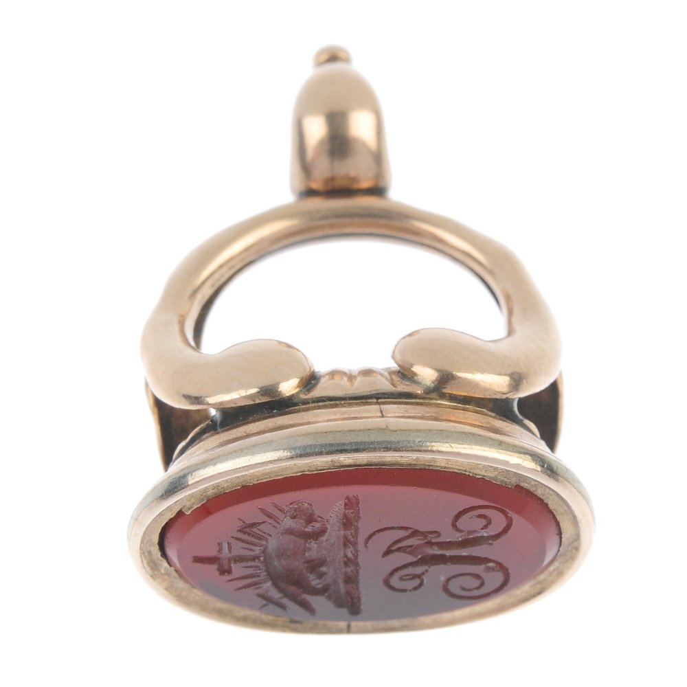 A fob.: A fob. The carnelian intaglio depicting an otter with reeds and a crucifix to the background and below the initials JC, to the scrolling pedestal. Length 2.8cms. Weight 8.5gms.