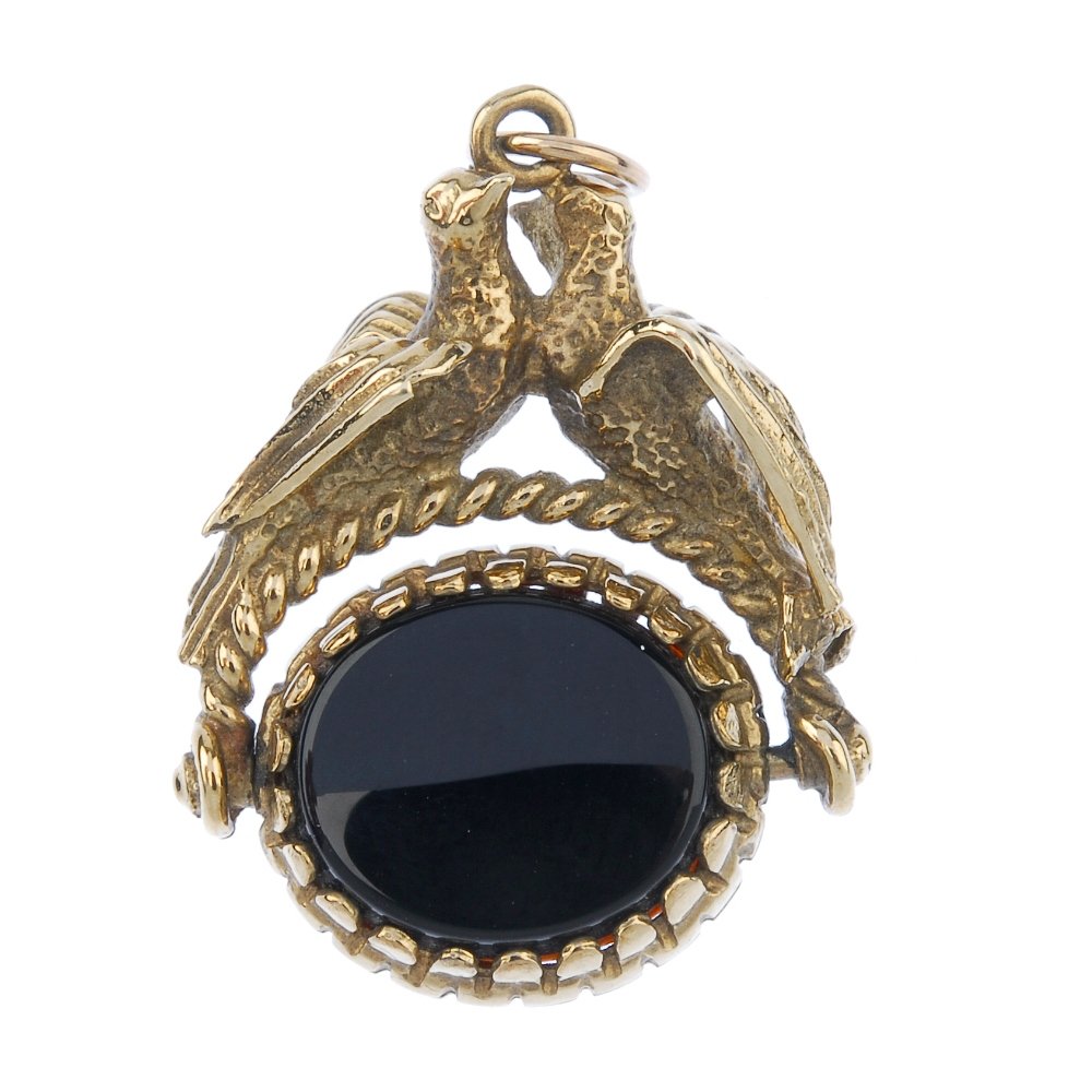A 9ct gold swivel fob.: A 9ct gold swivel fob. The swivel fob set with carnelian and onyx, to the twin bird pedestal. Hallmarks for Sheffield, 1994. Length 3cms. Weight 8.2gms.