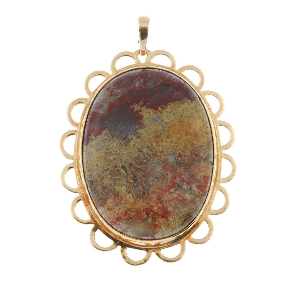 A 9ct gold agate pendant.: A 9ct gold agate pendant. The oval agate cabochon, within a scalloped border. Hallmarks for London, 1961. Length 5.8cms. Weight 18gms.