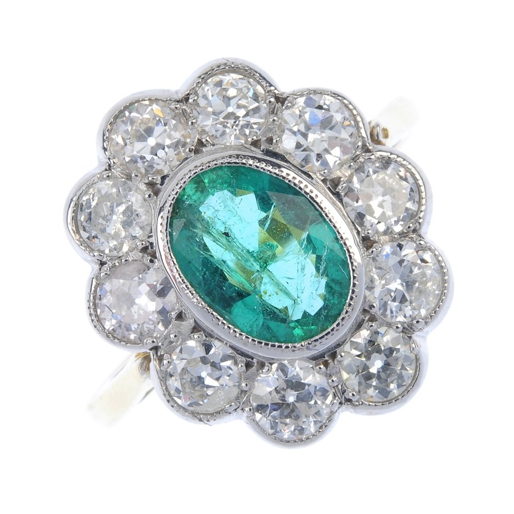 An 18ct gold emerald and diamond cluster ring. (1 of 4)