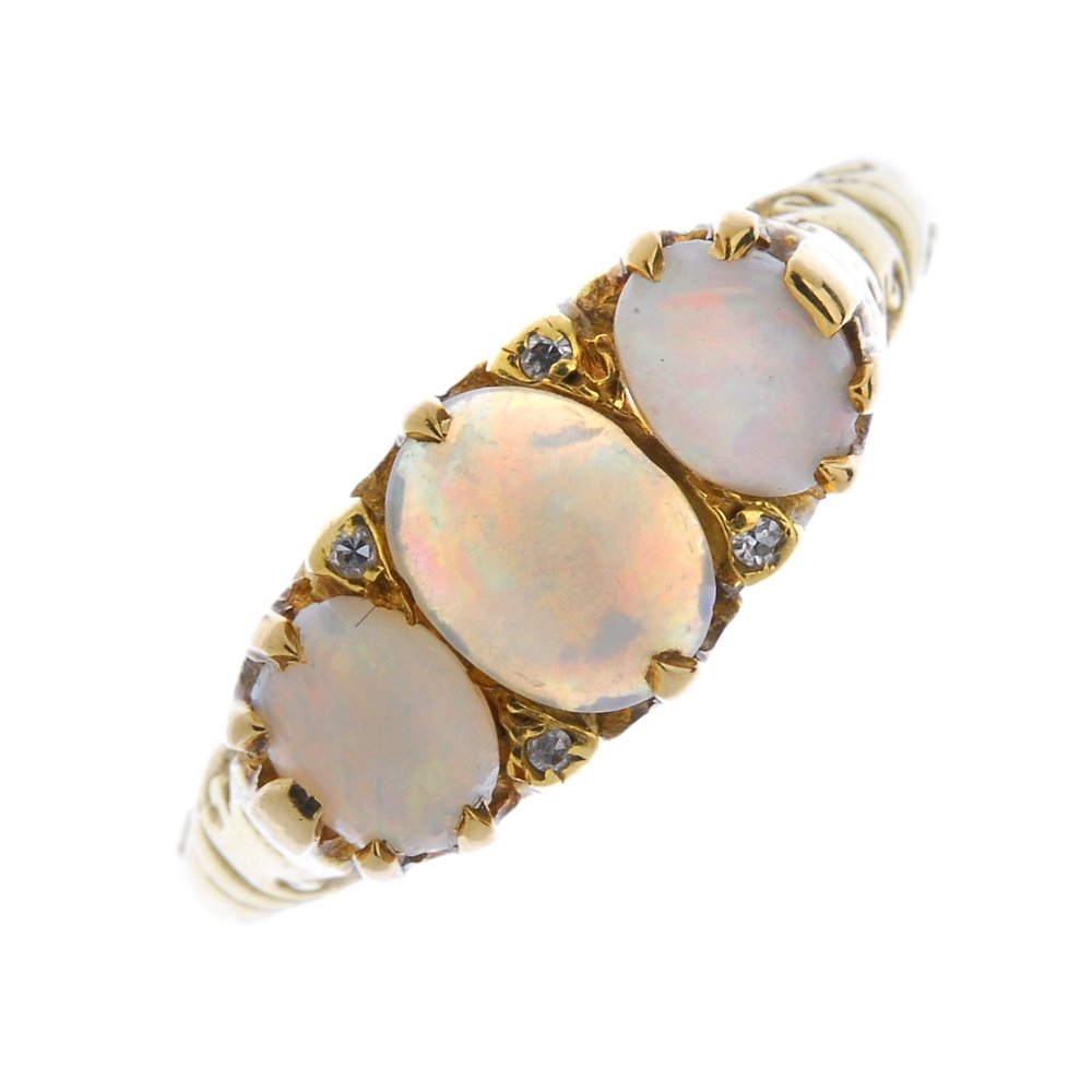 An 18ct gold opal and diamond three-stone ring. (1 of 4)