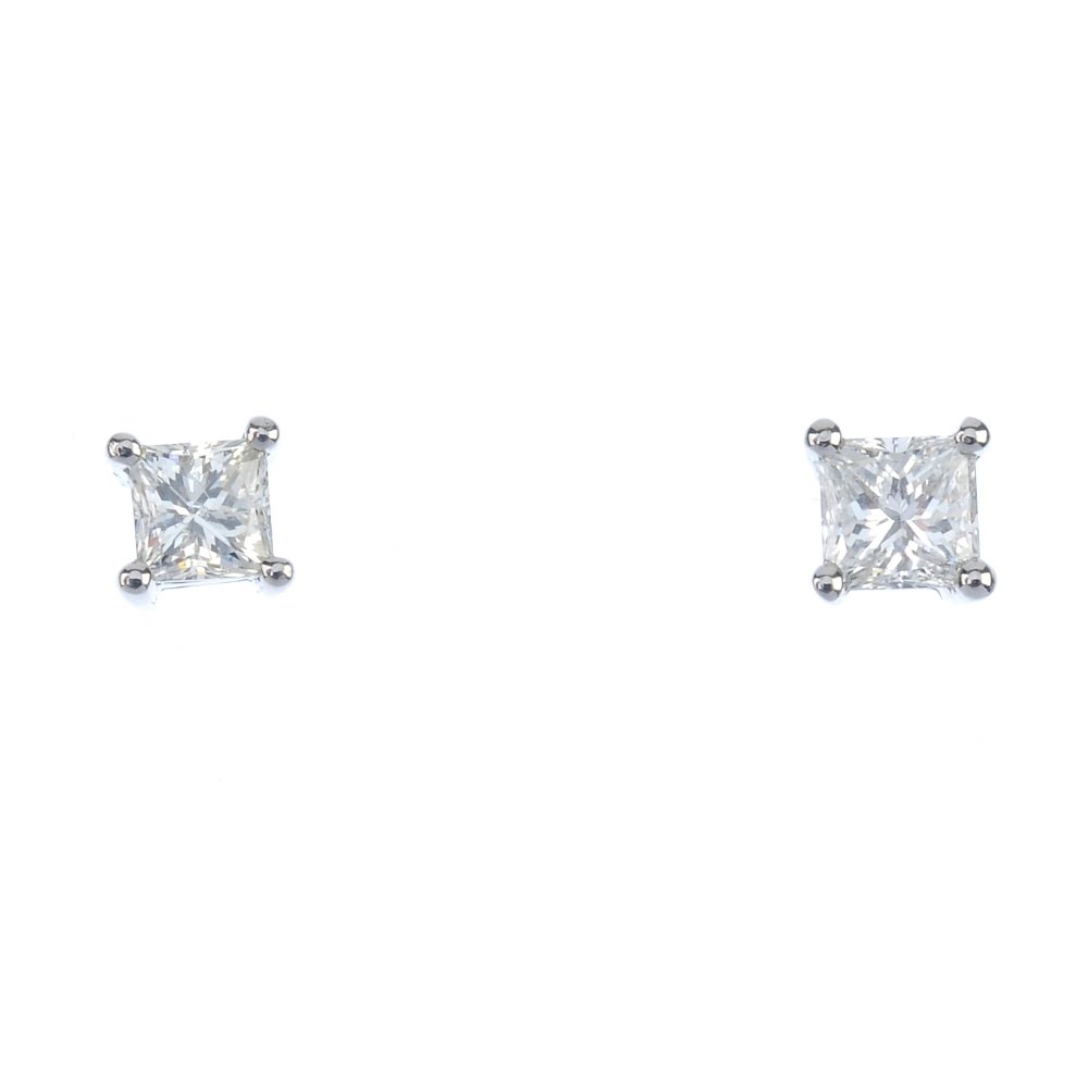 A pair of platinum square-shape diamond ear studs. (1 of 2)