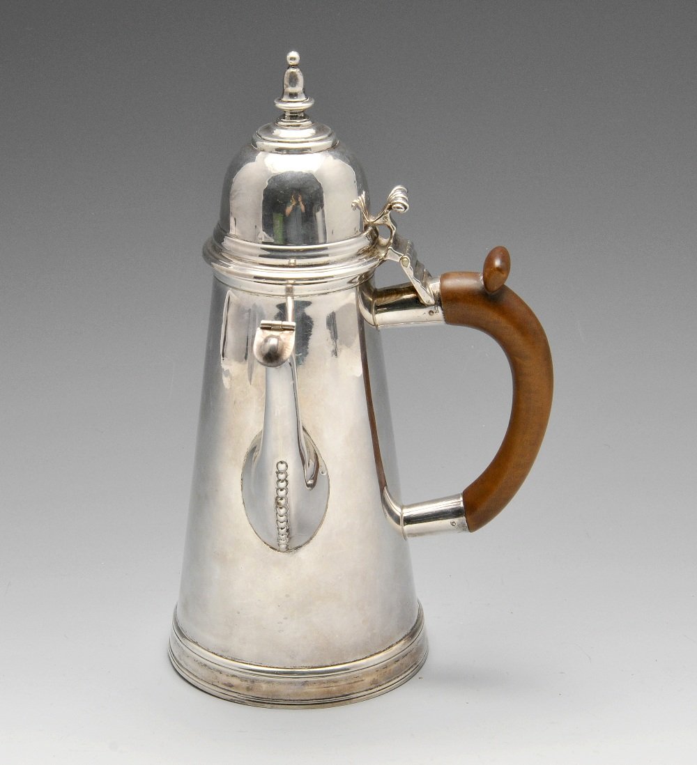 An Edwardian Britannia silver chocolate pot.: An Edwardian Britannia silver chocolate pot of traditional form, the plain tapering body, to the bead embellished spout, domed hinged cover with shaped finial. Hallmarked Charles Stuart Harris, Britan