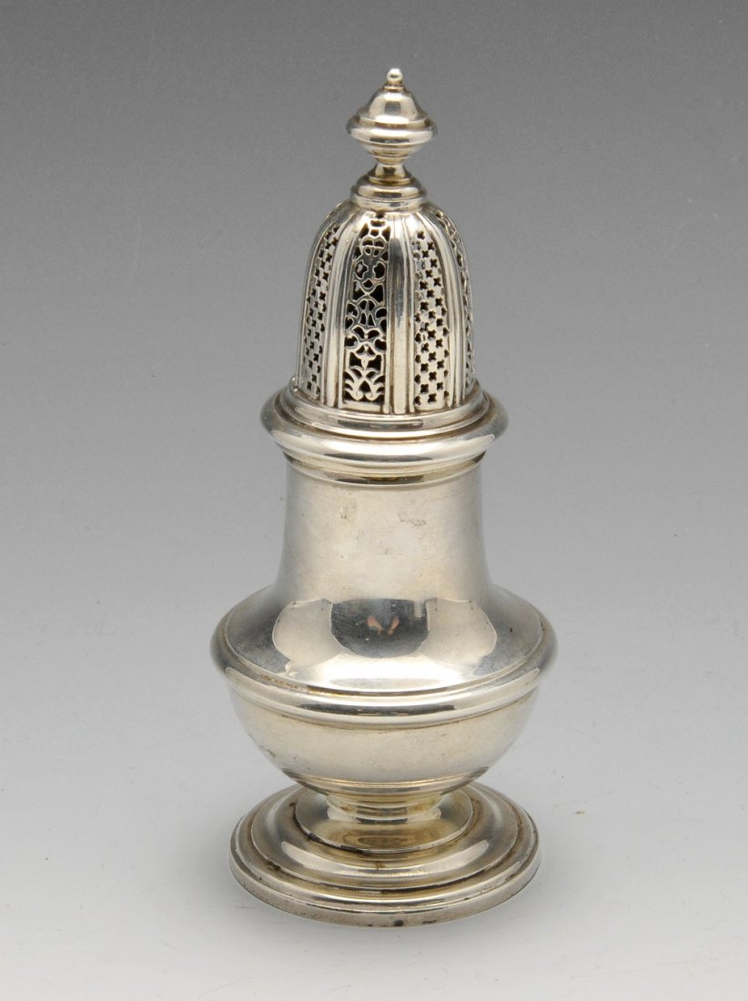 A modern silver caster in Georgian style.: A modern silver caster in Georgian style, the vase shaped body with embossed girdle, raised on a stepped circular foot and with pierced cover. Hallmarked William Comyns & Sons Ltd (Richard Comyns), Lo