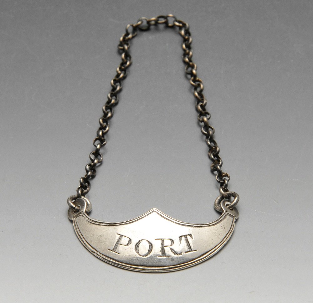An early nineteenth century silver wine label.: An early nineteenth century silver wine label of shaped form with reeded border and engraved 'PORT'. Hallmarked Edinburgh, the maker probably Robert Gray. Width measuring 4.3 cm, weight 6.8 grams.