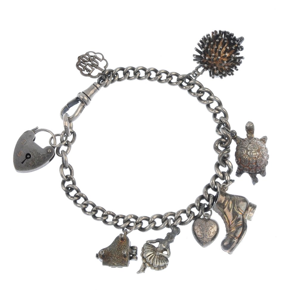 Four charm bracelets.: Four charm bracelets. The three curb-link and one fancy-link chain suspending a total of twenty-nine charms to include tortoise and elephant charms. Lengths 16 to 19cms. Weight 192.3gms.