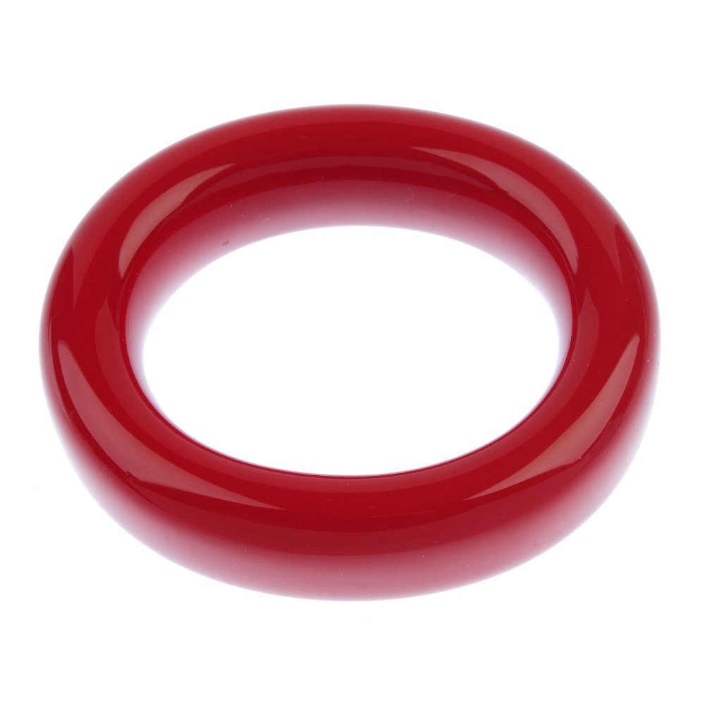 TIFFANY & CO. - an Elsa Peretti red lacquer bangle.: TIFFANY & CO. - an Elsa Peretti red lacquer bangle. Designed as an open oval-shape bangle of Japanese hardwood, lacquered in red. Signed Tiffany & Co. Elsa Peretti, Japan. Inner diameter 6.5cms. With
