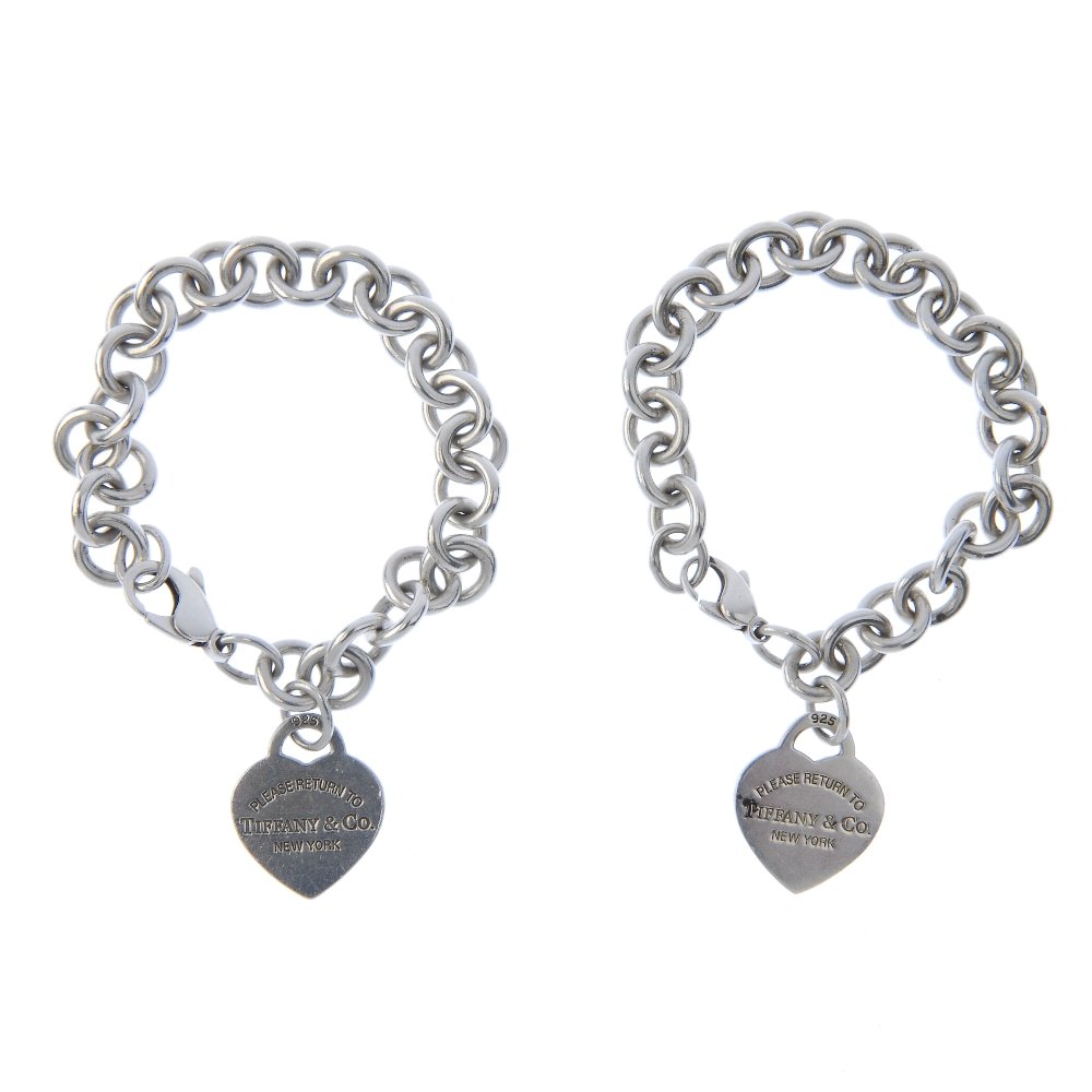 TIFFANY & CO. - two bracelets.: TIFFANY & CO. - two bracelets. Both designed as belcher-link bracelets each suspending a heart-shape 'Please return to Tiffany' charm. Signed Tiffany & Co. Hallmark for London, 2010. Lengths 19cms. We