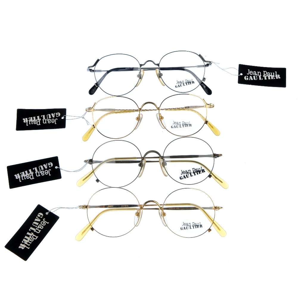 JEAN PAUL GAULTIER - four pairs of glasses.: JEAN PAUL GAULTIER - four pairs of display glasses. All of the same design, differing in colour, featuring thin metal frames, circular lenses and maker's initials at each temple. All with maker's disp