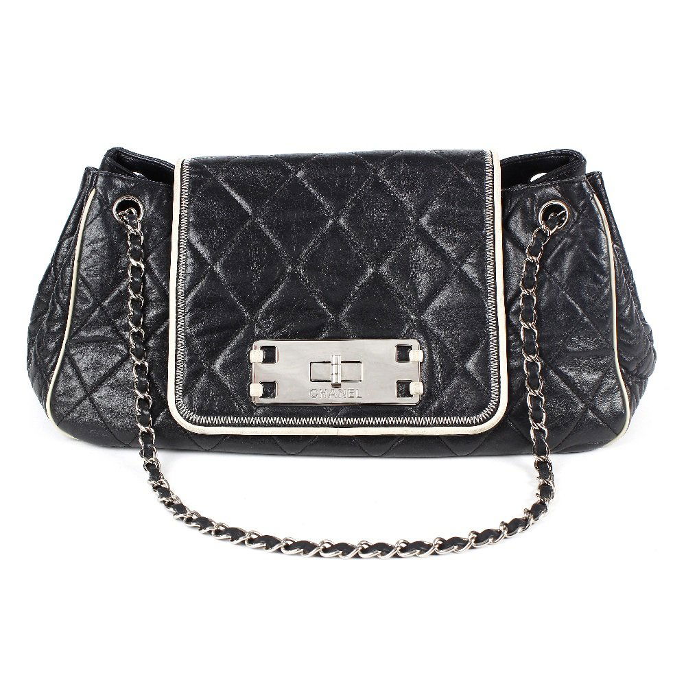 CHANEL - an East West Accordion Flap bag.: CHANEL - an East West Accordion Flap bag. From the maker's East West Collection, designed with a black quilted, glazed lambskin leather exterior and contrasting cream trim, dual chain-link and leather