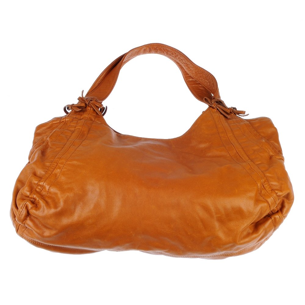 DKNY - a tan leather shoulder bag.: DKNY - a tan leather shoulder bag. Designed with two flat leather handles, ruched side with bow details and a magnetic fastening. Measuring 30 by 40cms. With maker's dust bag.