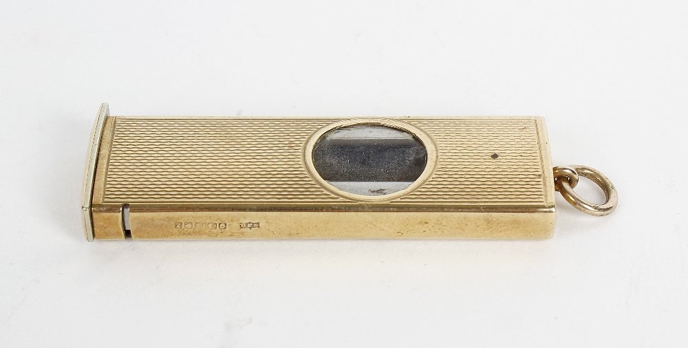 A 1980's 9ct cased cigar cutter.: A 1980's 9ct cased cigar cutter. Of rectangular form having textured surface and circular aperture enclosing the steel blade, hallmarked London 1983, 2" (5 cm) long.