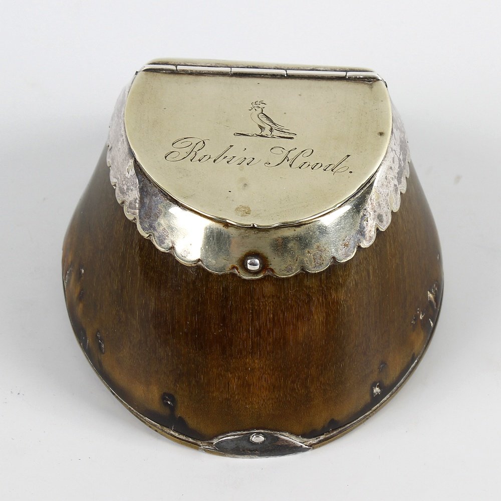 A Victorian novelty horse hoof table snuff box: A Victorian novelty horse hoof table snuff box. The hinged silver-plated cover engraved with a crest (a bird) and "Robin Hood" in cursive script, over frilled apron and horseshoe base, 4" wide x 2.5" 