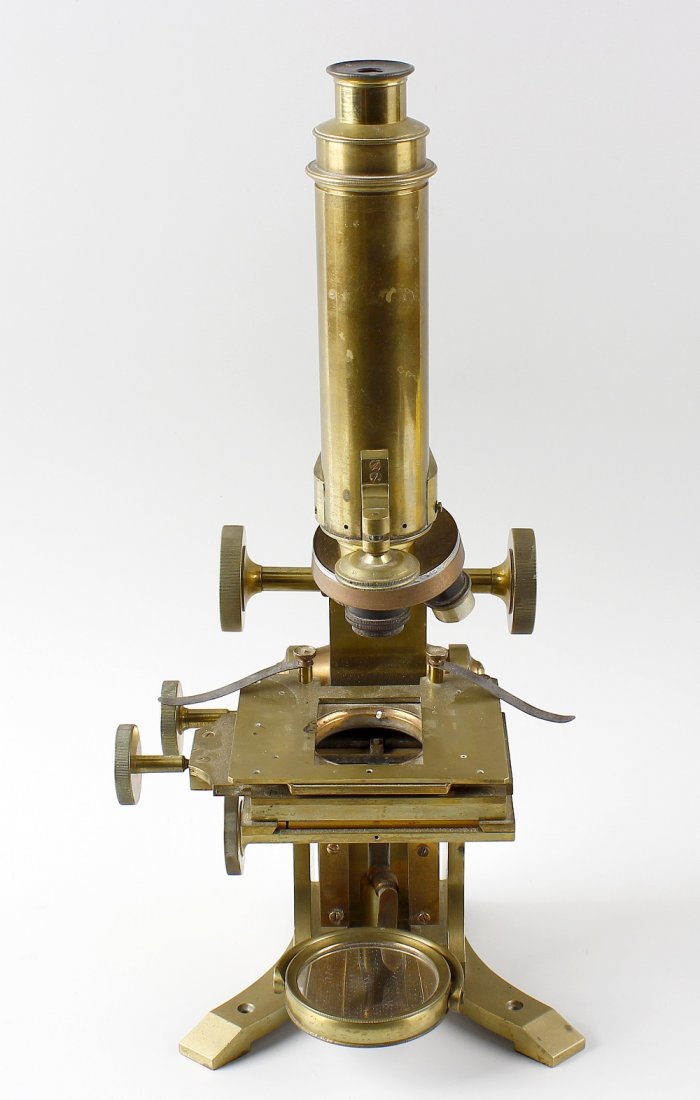 Monocular microscope and Zeliss Binoculars: A monocular brass microscope, having rack and pinion coarse adjustment above an adjustable rectangular stage and plano-concave mirror upon a Y-form base, 16" (40.5 cm) high. Together with a pair of Ca