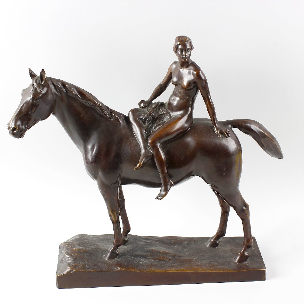 An Art Deco bronze figure group.: An Art Deco bronze figure group. Modelled as a female nude sat upon a horse, probably depicting Lady Godiva, stood upon rectangular naturalistic base, 16.75" (42.5 cm). (a/f).