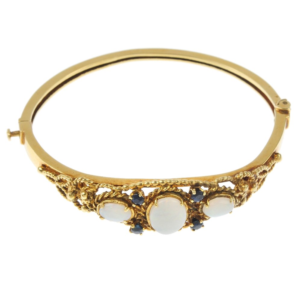 An opal and sapphire hinged bangle. (1 of 3)
