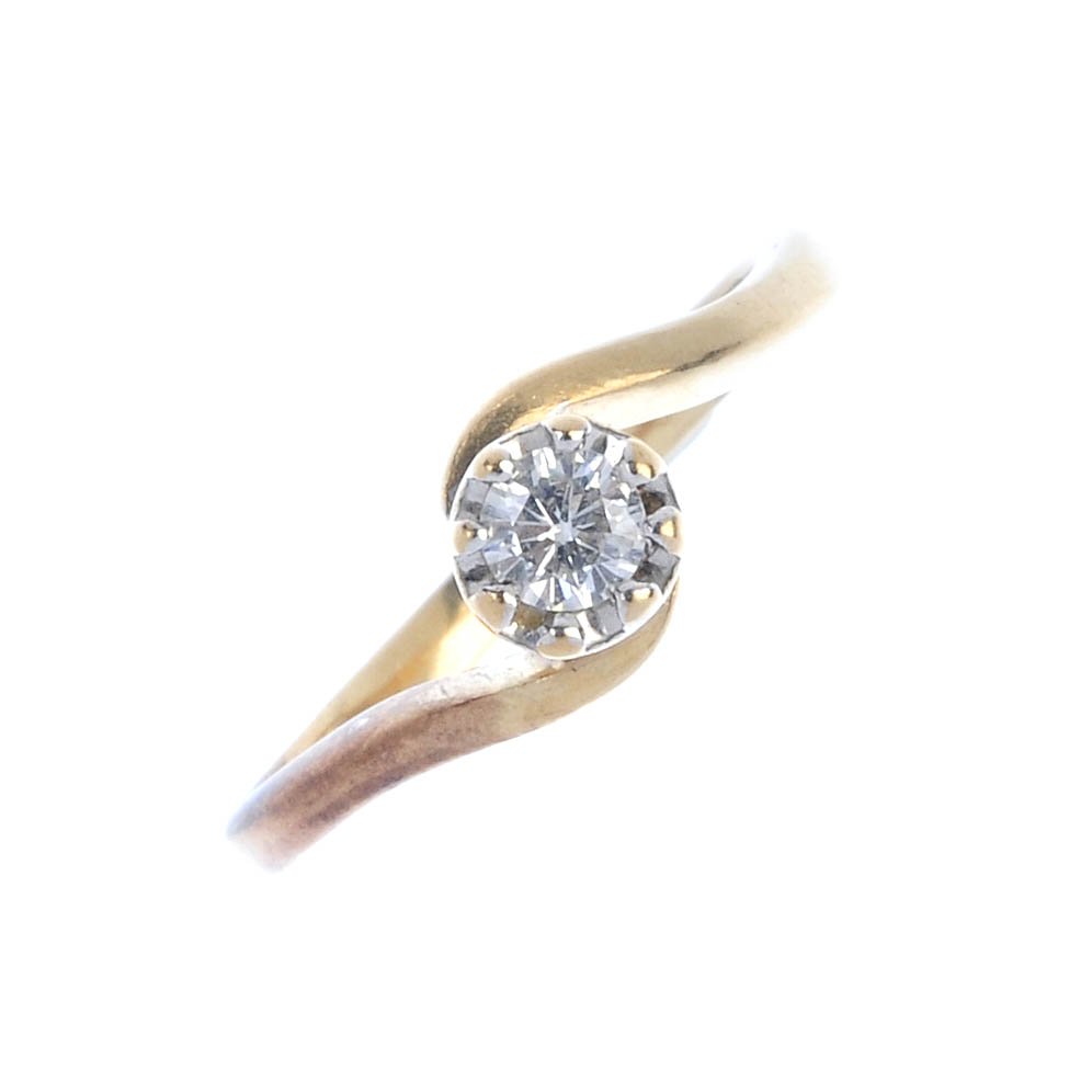 A 9ct gold diamond single-stone crossover ring. (1 of 3)