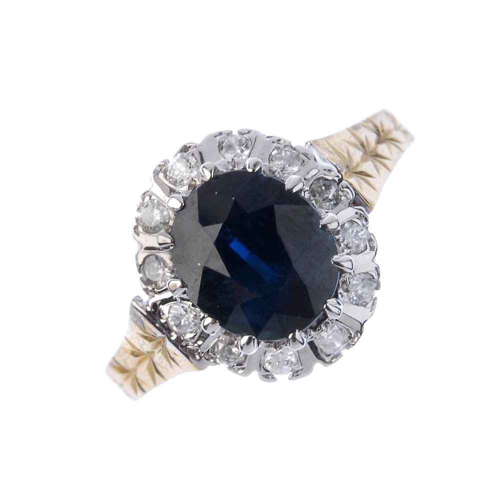 A 9ct gold sapphire and diamond cluster ring. (1 of 4)