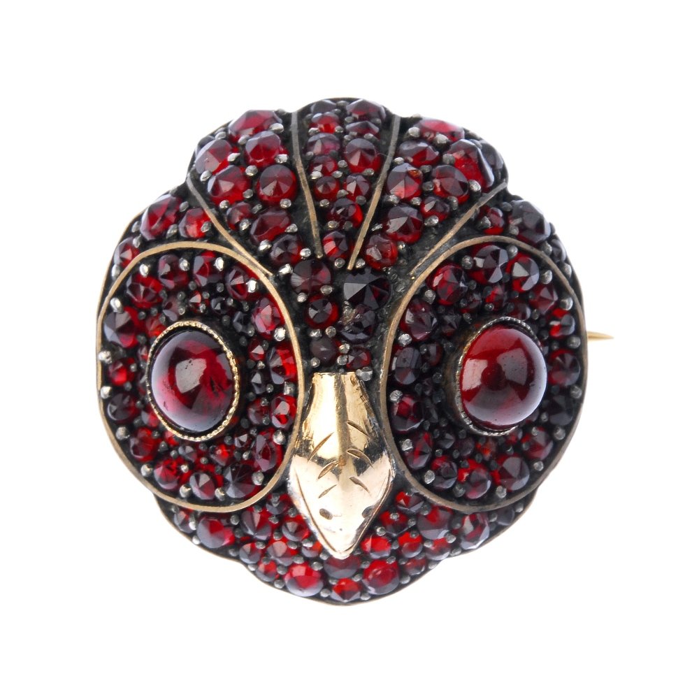 A late 19th century gold garnet owl brooch. (1 of 2)