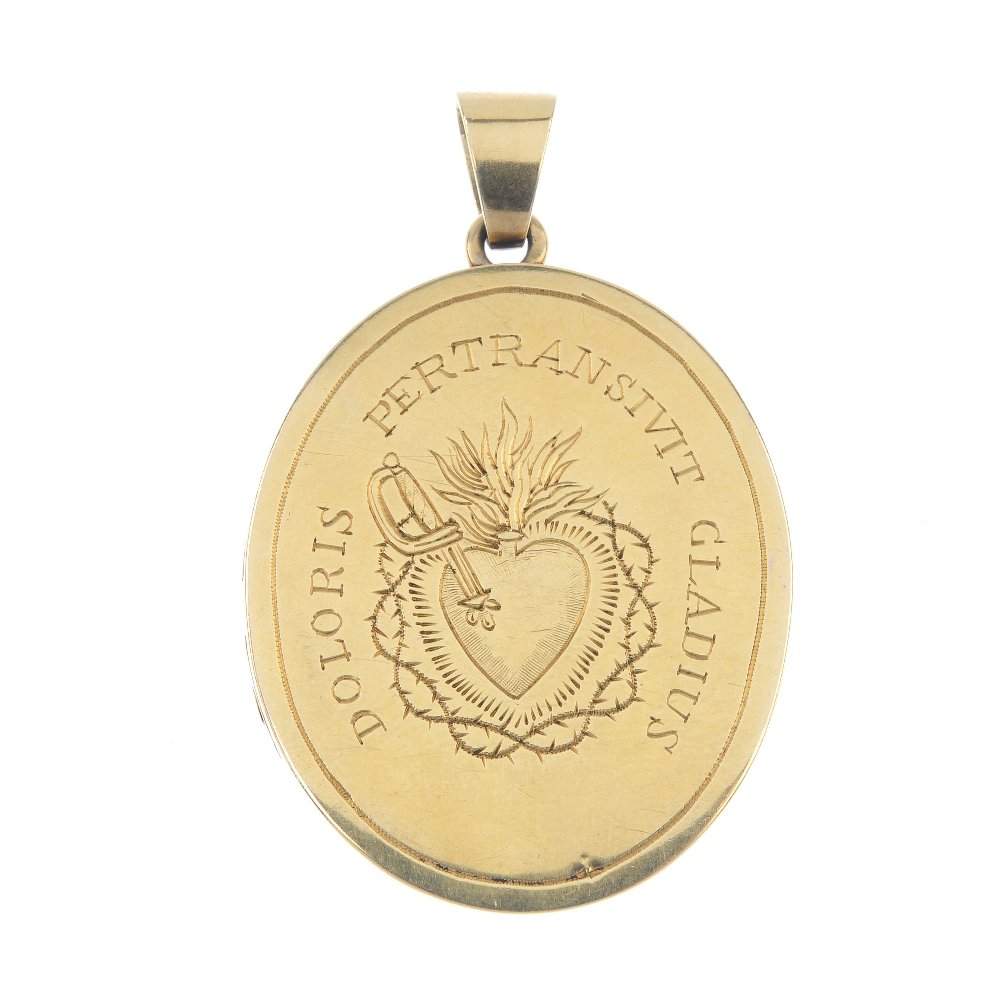 An oval locket.: An oval locket. Both sides with a central engraved picture of a heart pierced by a dagger with flames rising from the top and surrounded by barbed wire, to one side the words 'Doloris pertransivit gla