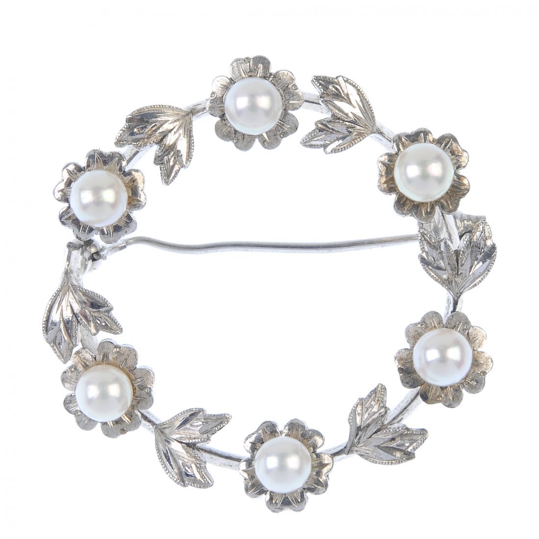 MIKIMOTO - a cultured pearl wreath brooch.: MIKIMOTO - a cultured pearl wreath brooch. Designed as a series of cultured pearl flowers, with foliate intervals. Split through brooch frame. Maker's mark for Mikimoto. Mark indicating silver. Diamet