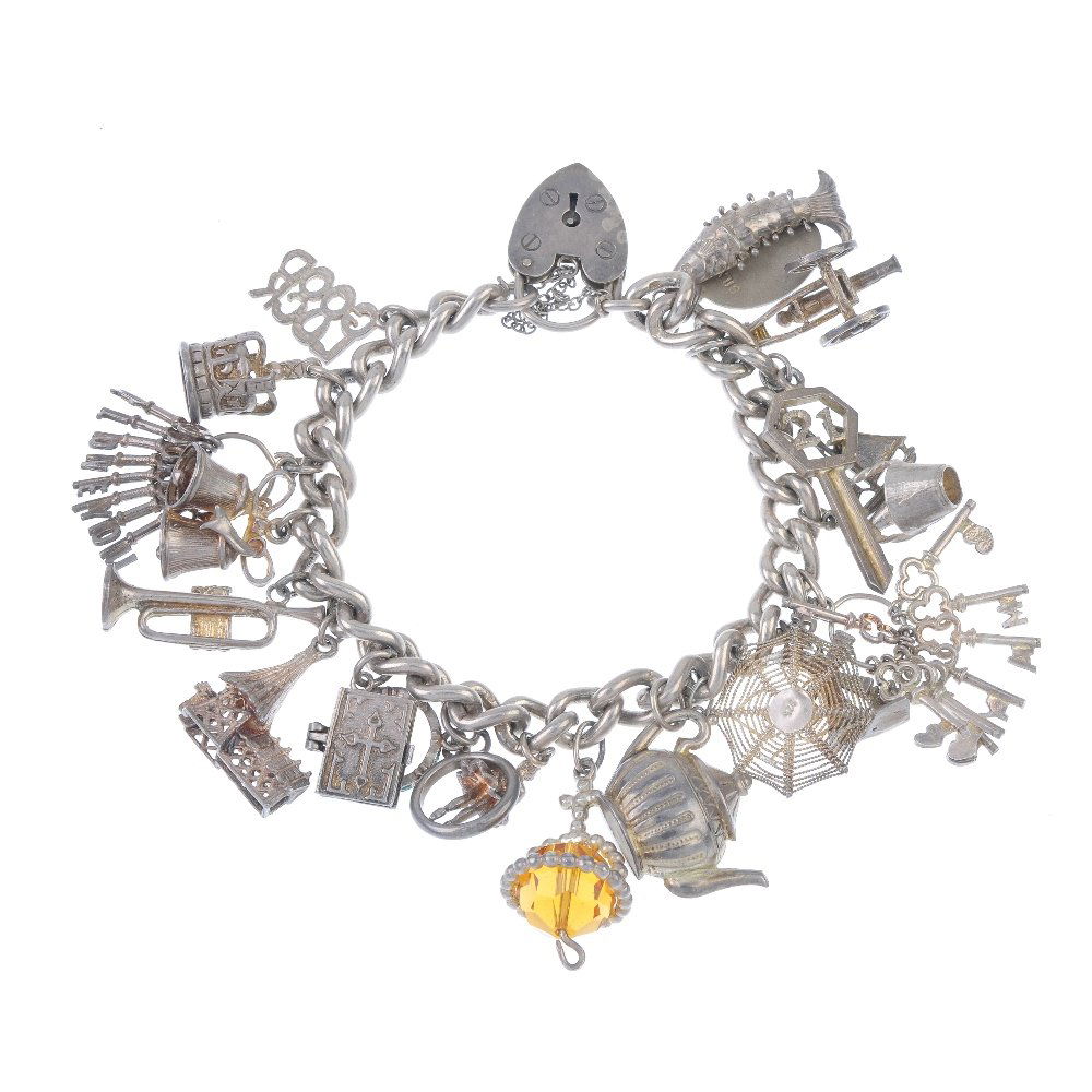 Two charm bracelets.: Two charm bracelets. One designed as a curb-link chain, the other as a double curb-link chain, both to the heart-shape padlock clasps, suspending a total of thirty charms, to include a spider on a web