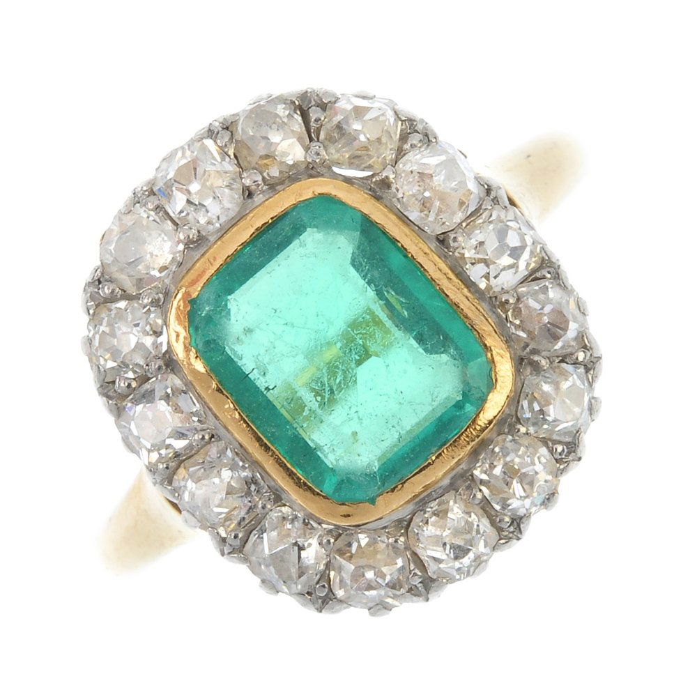 An emerald and diamond cluster ring. (1 of 3)