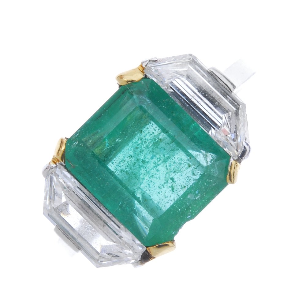 An emerald and diamond three-stone ring. (1 of 3)