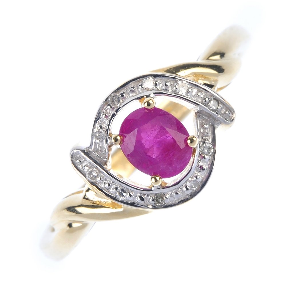 A 9ct gold ruby and diamond dress ring. The oval-shape (1 of 4)