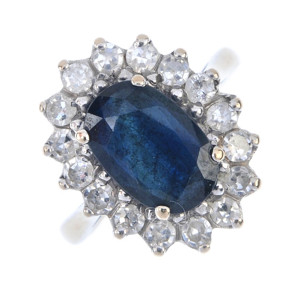 An 18ct gold sapphire and diamond cluster ring. The (1 of 3)