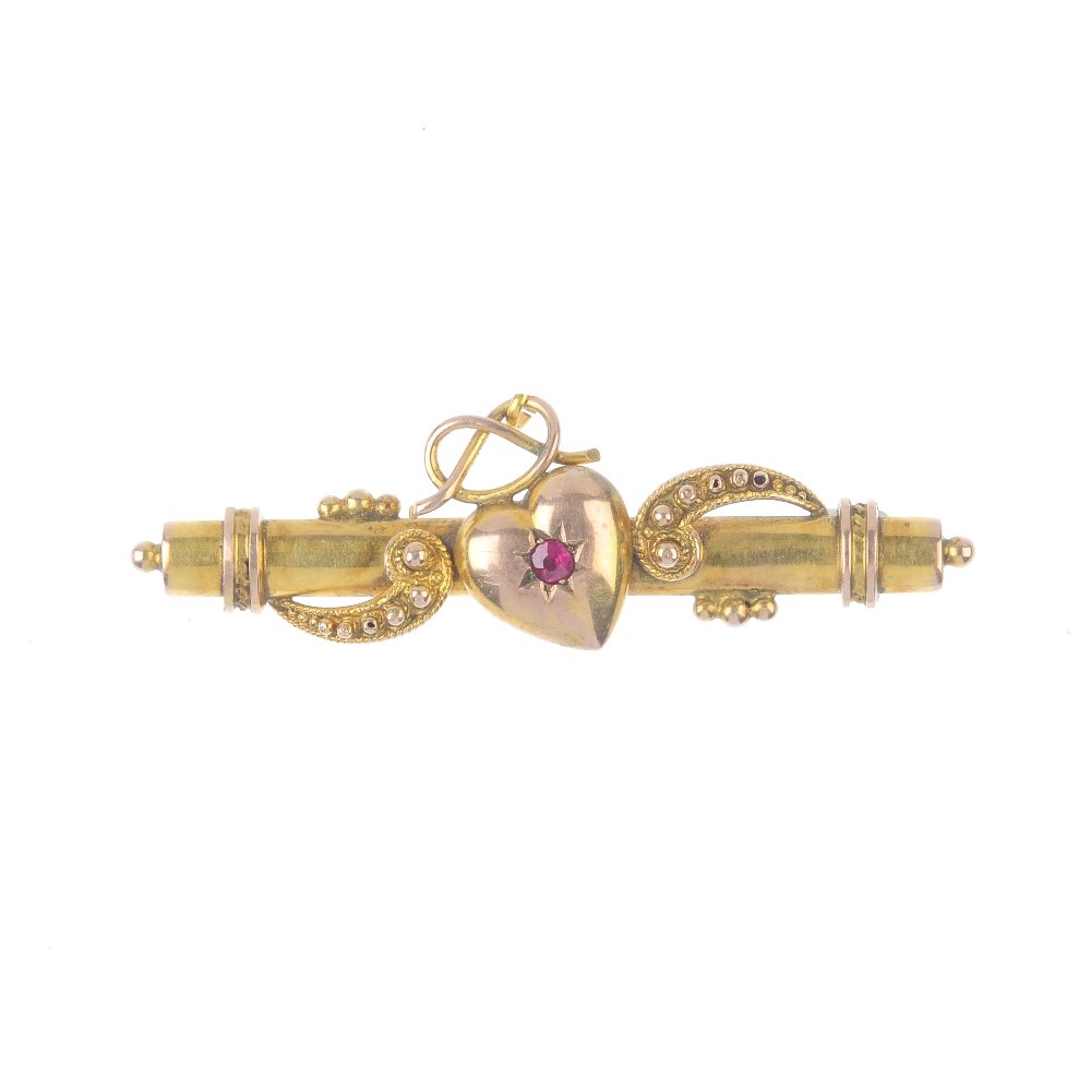 An early 20th century gold ruby bar brooch. The (1 of 3)