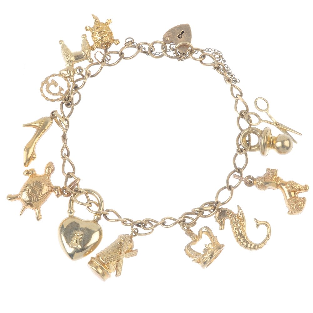 A 9ct gold charm bracelet. The flat curb-link chain, (1 of 2)
