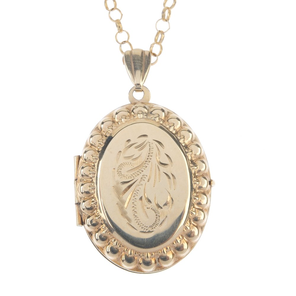A 9ct gold locket, with chain. Of oval outline, the (1 of 2)