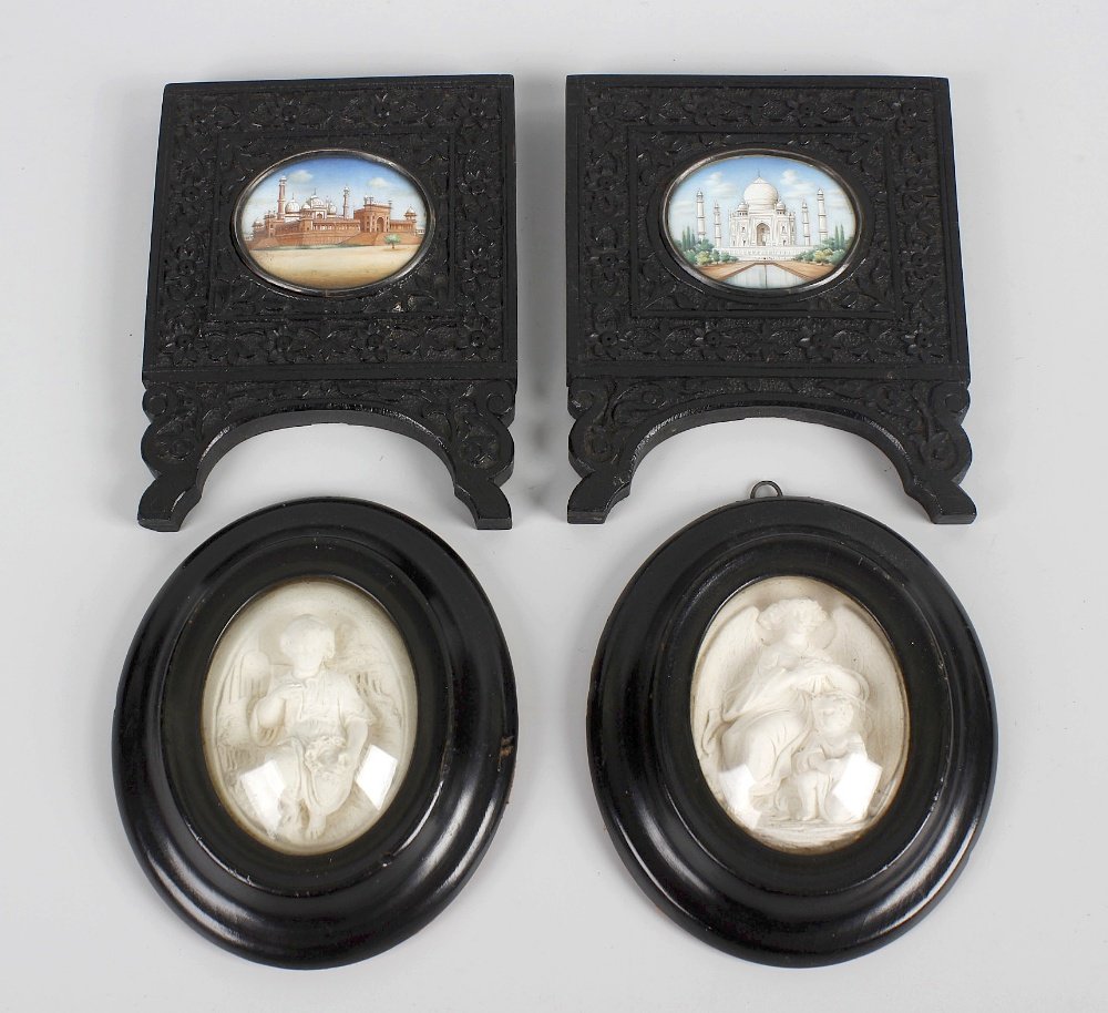 A group of miniatures, comprising a pair of Indian: A group of miniatures, comprising a pair of Indian Mughal-style miniatures, c. 1900, the first depicting the Taj Mahal, the second possibly illustrating the Red Fort in Agra, both in flower carved ebo