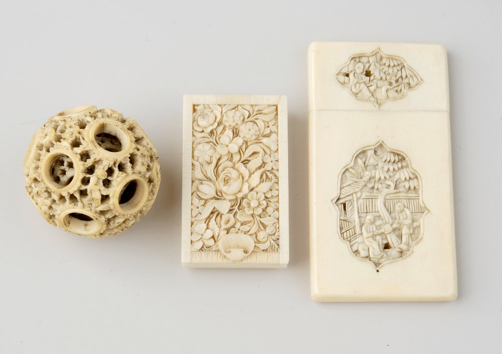 Three items of Chinese Canton carved ivory. Comprising:: Three items of Chinese Canton carved ivory. Comprising: a visiting-card case with shaped recessed panels of figures to each side, 3.25, (8.2cm) high; a small box with sliding cover; and a small puzzle