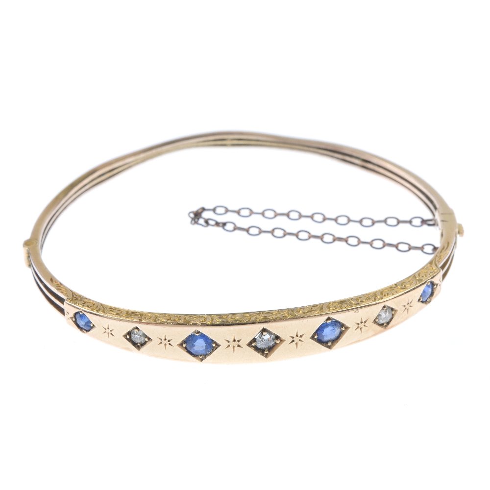 A mid 20th century diamond and sapphire hinged bangle. (1 of 3)