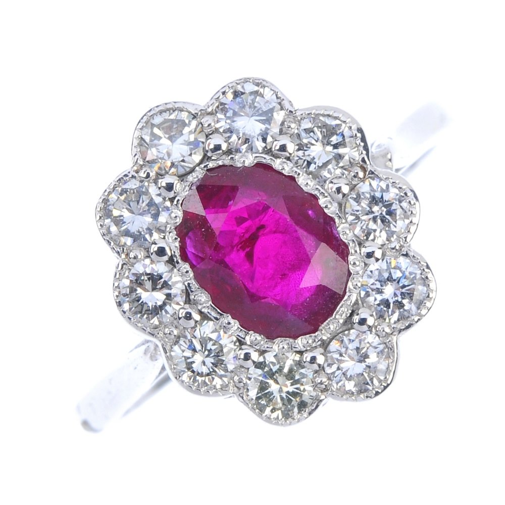 An 18ct gold ruby and diamond cluster ring. The (1 of 3)