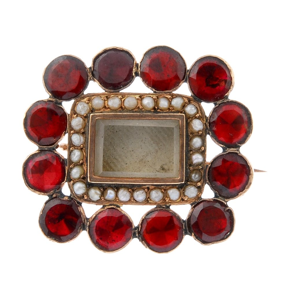 A garnet and split pearl mourning brooch. The (1 of 2)