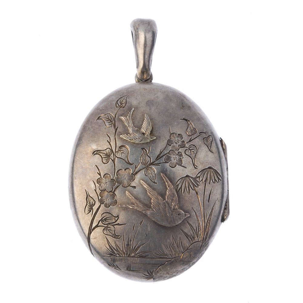 A late Victorian silver locket. Of oval outline, the (1 of 2)