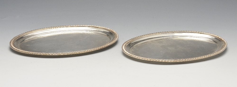 A pair of small silver salvers of oval form, each: A pair of small silver salvers of oval form, each having a gadroon rim to a plain centre. Hallmarked Roberts & Belk Ltd., Sheffield 1968. Length measuring 8 3/4 inches (22.2 cm), weight 18.35 ozt (570