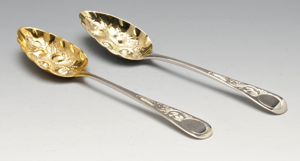 A pair of George III silver berry spoons, each with (1 of 10)
