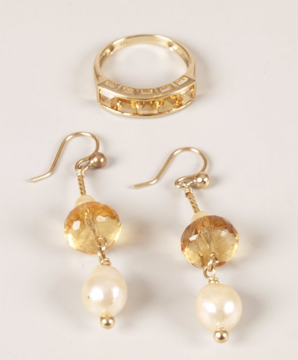 Two items of jewellery to include a 9ct gold five: Two items of jewellery to include a 9ct gold five stone ring with channel set square step cut citrines and a pair of citrine and cultured pearl dropper earrings in a twisted bar design leading to a pe