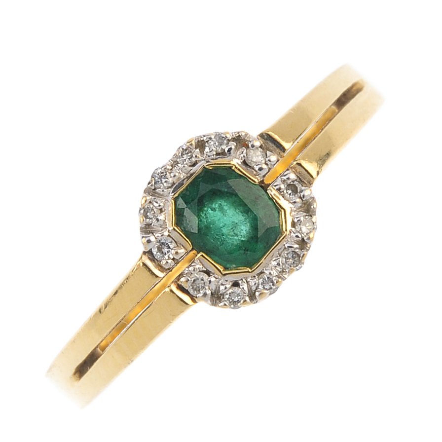 An 18ct gold emerald and diamond cluster ring. The (1 of 3)