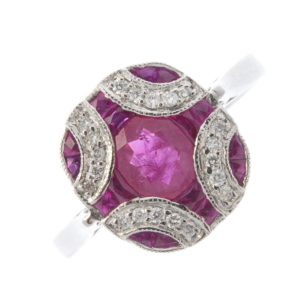 A ruby and diamond dress ring. The oval-shape ruby, (1 of 3)