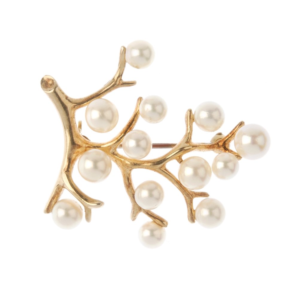 MIKIMOTO - a cultured pearl brooch. Of branch design,: MIKIMOTO - a cultured pearl brooch. Of branch design, set throughout with cultured pearls. Maker's mark for Mikimoto. Length 3.5cms. Weight 5.7gms. With maker's pouch. Overall condition good. Surface 
