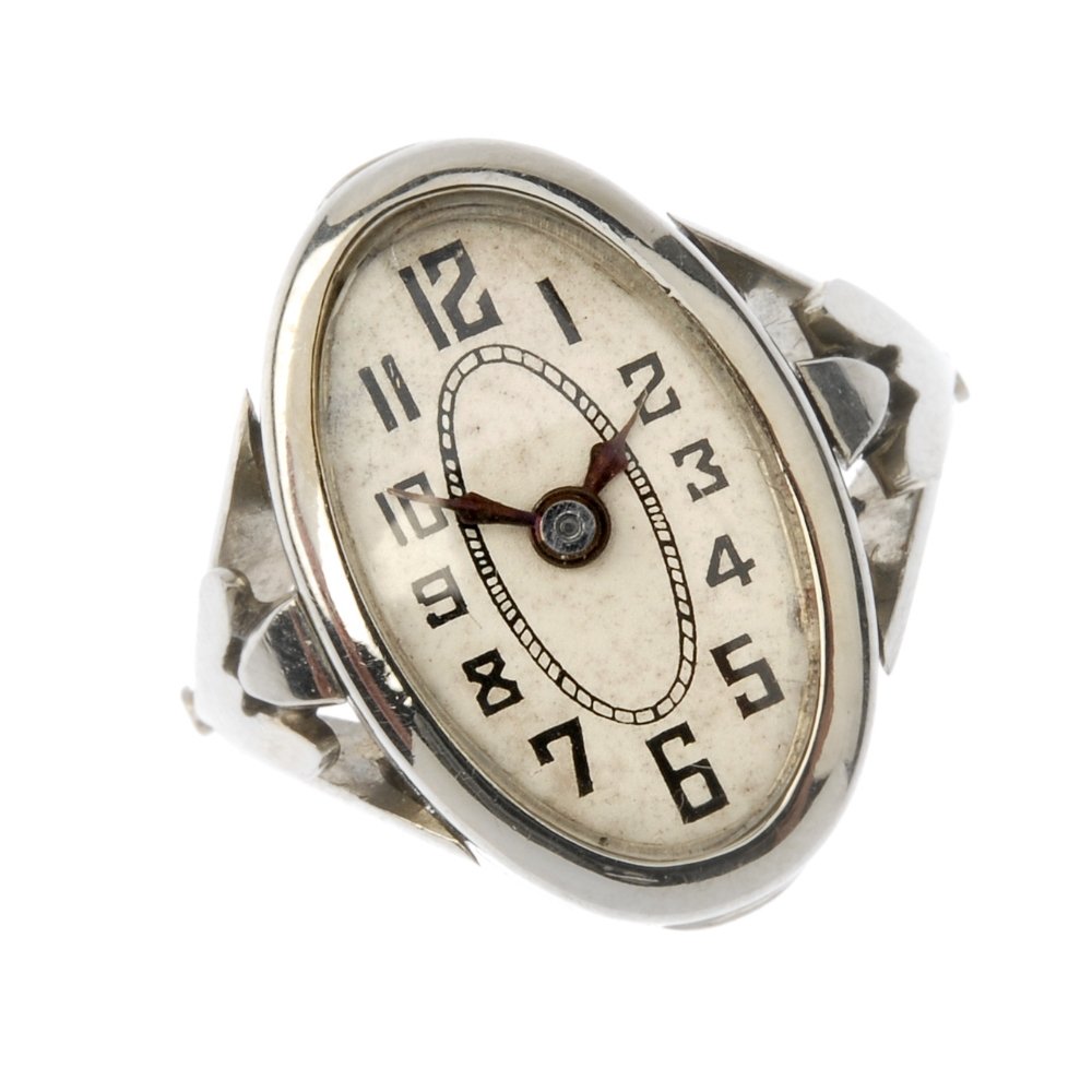 An Art Deco 18ct gold watch ring. The oval-shape white (1 of 3)