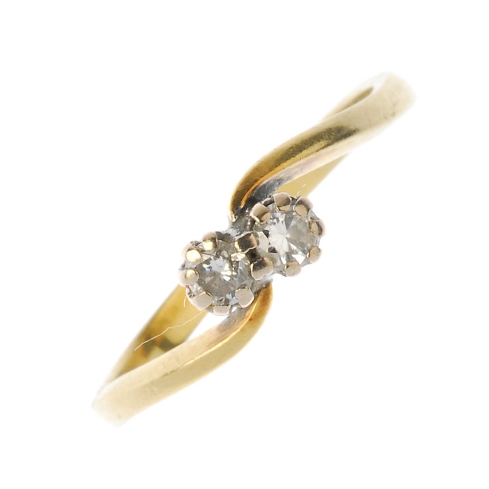 An 18ct gold diamond two-stone crossover ring. The (1 of 3)