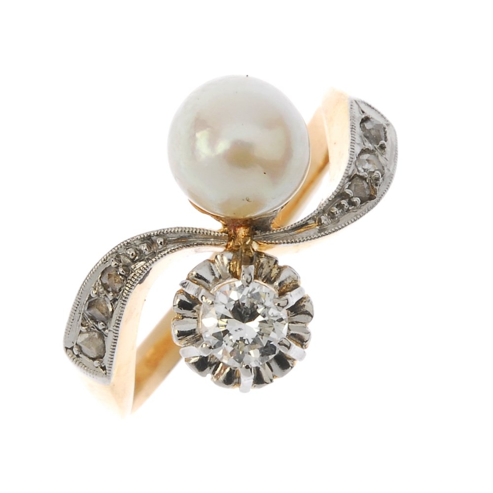 A diamond and cultured pearl crossover ring. The (1 of 3)